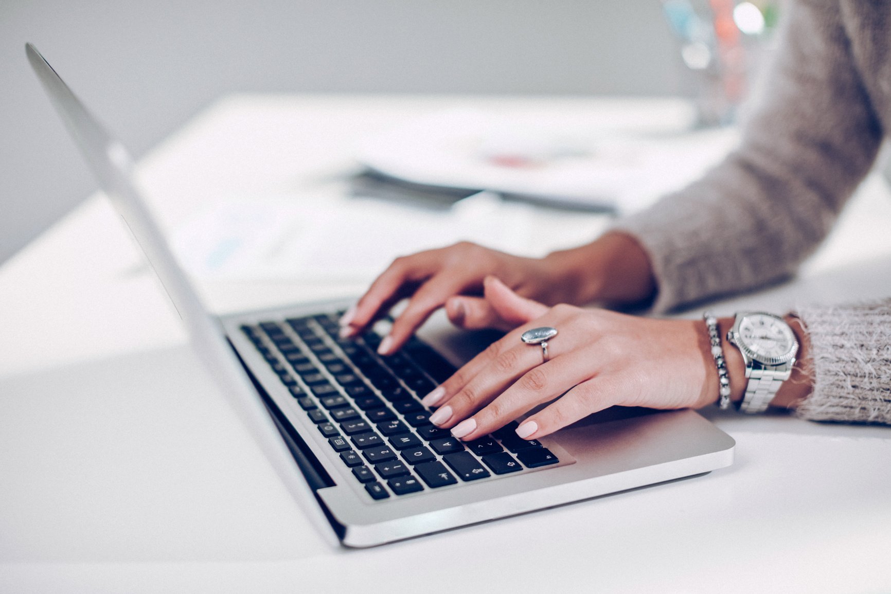 Women hands typing on laptop keyboard