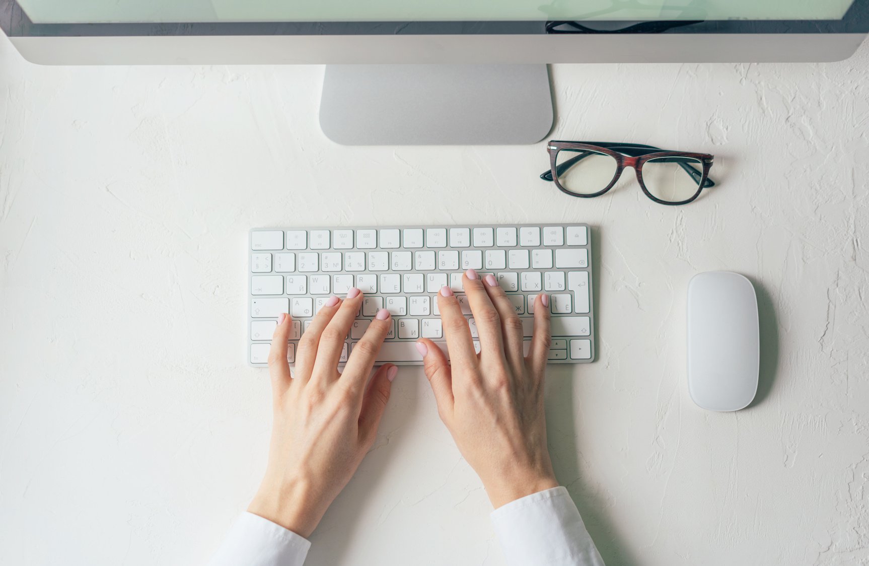 Hands Typing on Keyboard at Home Computer